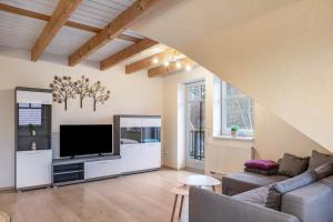 a living room with a couch and a flat screen tv at Ferienhaus Hof Schäfer in Waldeck