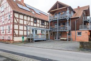 a row of wooden houses with balconies and a street at Ferienhaus Hof Schäfer in Waldeck