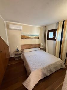 a bedroom with a large bed in a room at Sardinia house with beautiful view near sea in Brunella