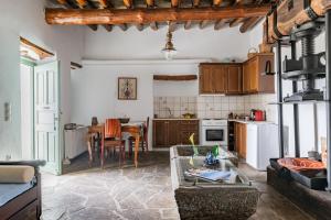 a living room with a table and a kitchen at Olive Guesthouse near farm in Fállika +12 photos