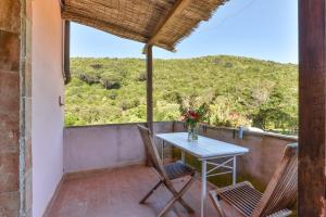a table and chairs on a balcony with a view at Agriturismo Amandolo in Cavo +78 photos