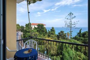 a balcony with a chair and a view of the ocean at La Ca' Di Marì in Costarainera