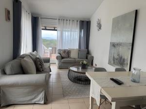 a living room with a couch and a table at Appartamento Sea View in Baja Sardinia