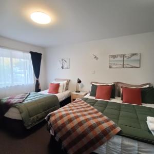 two beds sitting next to each other in a room at #4 Glenorchy Alpine Suite in Glenorchy