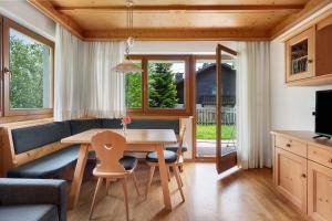 a kitchen and dining room with a table and chairs at Villa Nussbaumer in Siusi