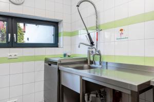 a kitchen with a sink and a window at Ferienhaus Buwesch 13 in Nüsttal +17 photos