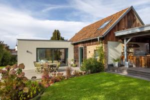 a garden with a house with a patio at Ferienhaus Buwesch 13 in Nüsttal