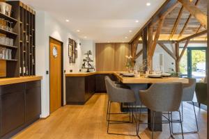 a kitchen with a dining table and chairs at Ferienhaus Buwesch 13 in Nüsttal