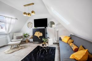 a living room with a couch and a tv at Deluxe Apartment in Duisburg