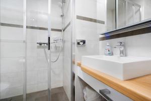 a white bathroom with a sink and a shower at Ferienanlage in Großkoschen +72 photos