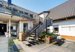 a house with a staircase in front of it at Ferienanlage in Großkoschen