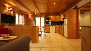 a kitchen and living room in a log cabin at Chalet Alpaga 6 in Bonneval-sur-Arc