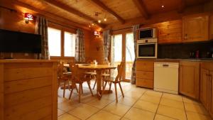a kitchen and dining room with a table and chairs at Chalet Alpaga 6 in Bonneval-sur-Arc