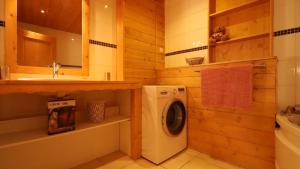 a bathroom with a washing machine and a sink at Chalet Alpaga 6 in Bonneval-sur-Arc +4 photos