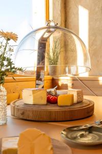 a plate of cheese on a table with a lamp at Rossalm in Brixen +45 photos