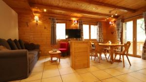 a living room with a couch and a table and chairs at Chalet Alpaga 6 in Bonneval-sur-Arc