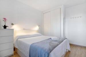 a white bedroom with a bed and a dresser at Casa Gloria in Puerto del Carmen +12 photos
