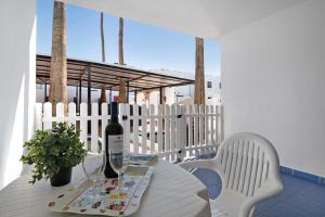 a bottle of wine sitting on a table on a balcony at Casa Gloria in Puerto del Carmen
