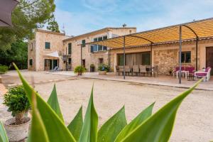 an outside view of a building with a patio at Finca Son Palanca in Sineu