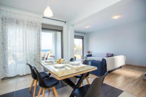 a living room with a dining room table and chairs at Rhodes Sea Villas No 2 in Ialysos