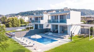 a large white house with a swimming pool at Rhodes Sea Villas No 2 in Ialysos