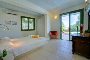 a bedroom with a bed and a sliding glass door at Villa Telina Ideales Resort in Kefallonia +15 photos