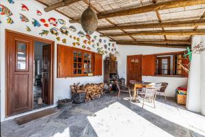 a kitchen with a table and chairs and a room at Casa do Mar in Sesimbra