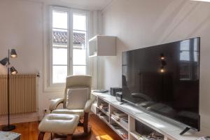 a living room with a large flat screen tv at Les Hirondelles Archiac in Archiac