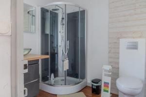 a bathroom with a shower with a glass door at Les Hirondelles Archiac in Archiac +20 photos