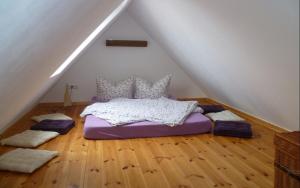 a bedroom with a purple bed in the attic at Auszeit Landleben in Sallgast