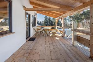 a wooden porch with a picnic table on a deck at Fewo am Flämingrand in Zahna-Elster