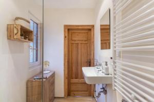 a bathroom with a sink and a wooden door at Homertstuebchen in Eslohe +15 photos