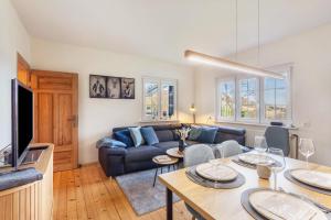 a living room with a couch and a table at Homertstuebchen in Eslohe