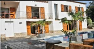 a villa with a swimming pool and a house at Villa Francisco in Calonge