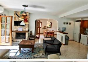 a living room with a couch and a fireplace at Villa Francisco in Calonge