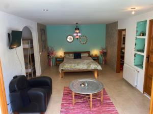 a bedroom with a bed and a couch and a table at Villa Francisco in Calonge