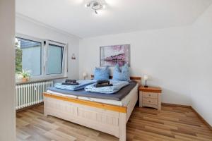 a bedroom with a bed with blue pillows on it at Lieblingsplatz in Küssaberg