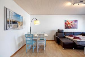 a living room with a couch and a table and chairs at Lieblingsplatz in Küssaberg