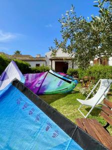 a swimming pool with a boat and a chair at Stagnone Area Zero in Birgi Vecchi +72 photos