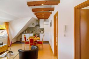 a kitchen and dining room with a table and chairs at Huus Nördernee 2 in Norderney