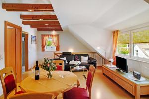 a living room with a table and a couch at Huus Nördernee 2 in Norderney