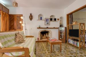 a living room with a couch and a fireplace at Studio with Private Garden in Lagos