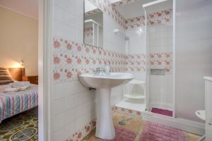 a bathroom with a sink and a shower at Studio with Private Garden in Lagos +12 photos