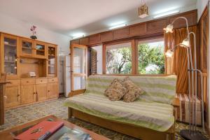 a living room with a couch and a window at Studio with Private Garden in Lagos