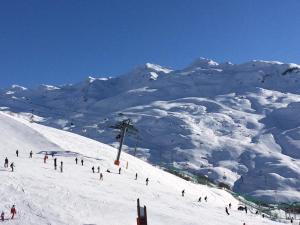 a group of people skiing down a snow covered mountain at Appartement N° 46 in Les Menuires