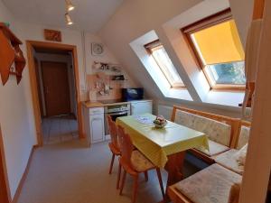 a kitchen and dining room with a table and chairs at Haus Am Waldrand in Freital