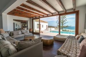 a living room with a couch and a table at The Cube in Zahara de los Atunes
