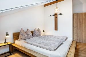 a bedroom with a bed with a cross on the wall at Wohnung Staufenblick in Freilassing
