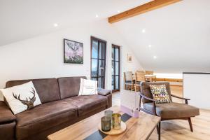 a living room with a couch and a table at Wohnung Staufenblick in Freilassing