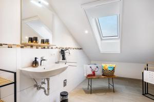 a bathroom with a sink and a window at Wohnung Staufenblick in Freilassing +23 photos